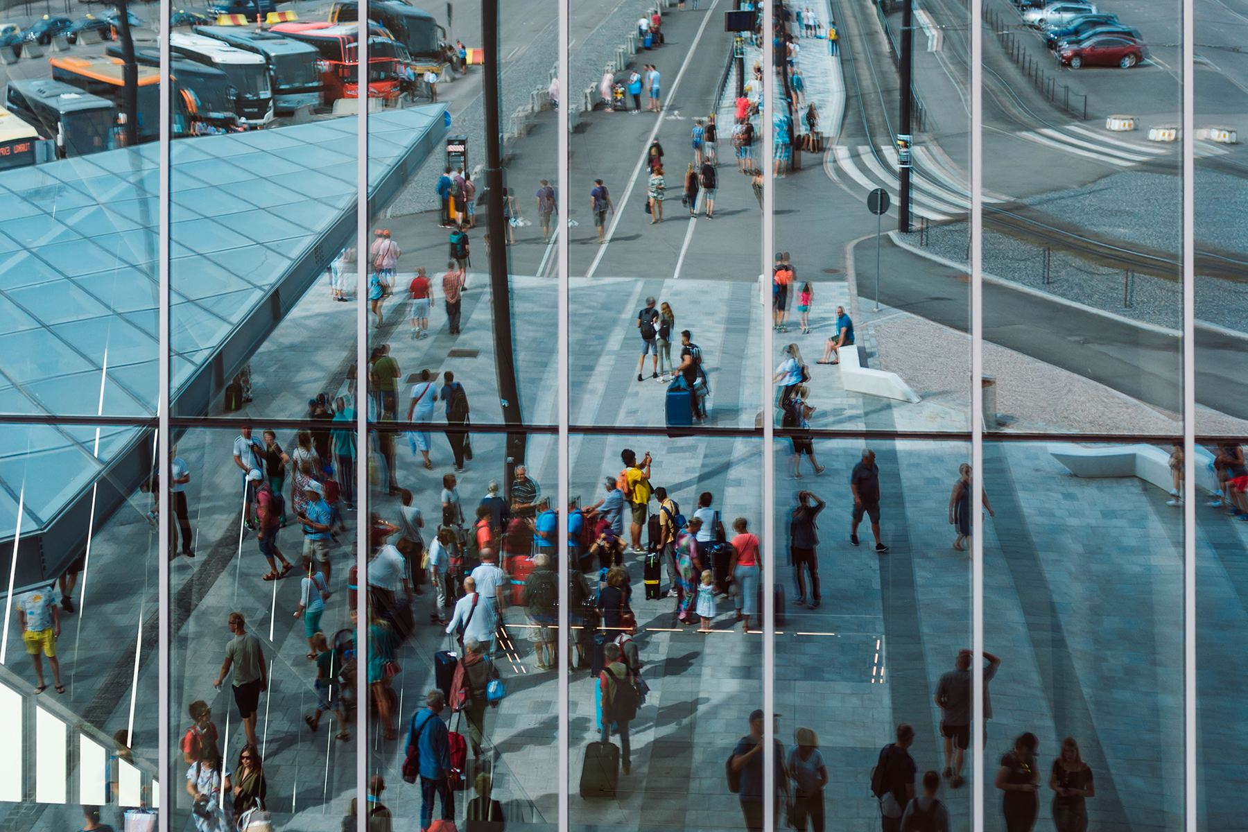 Illustration - large blue toned windows reflecting passengers go by.