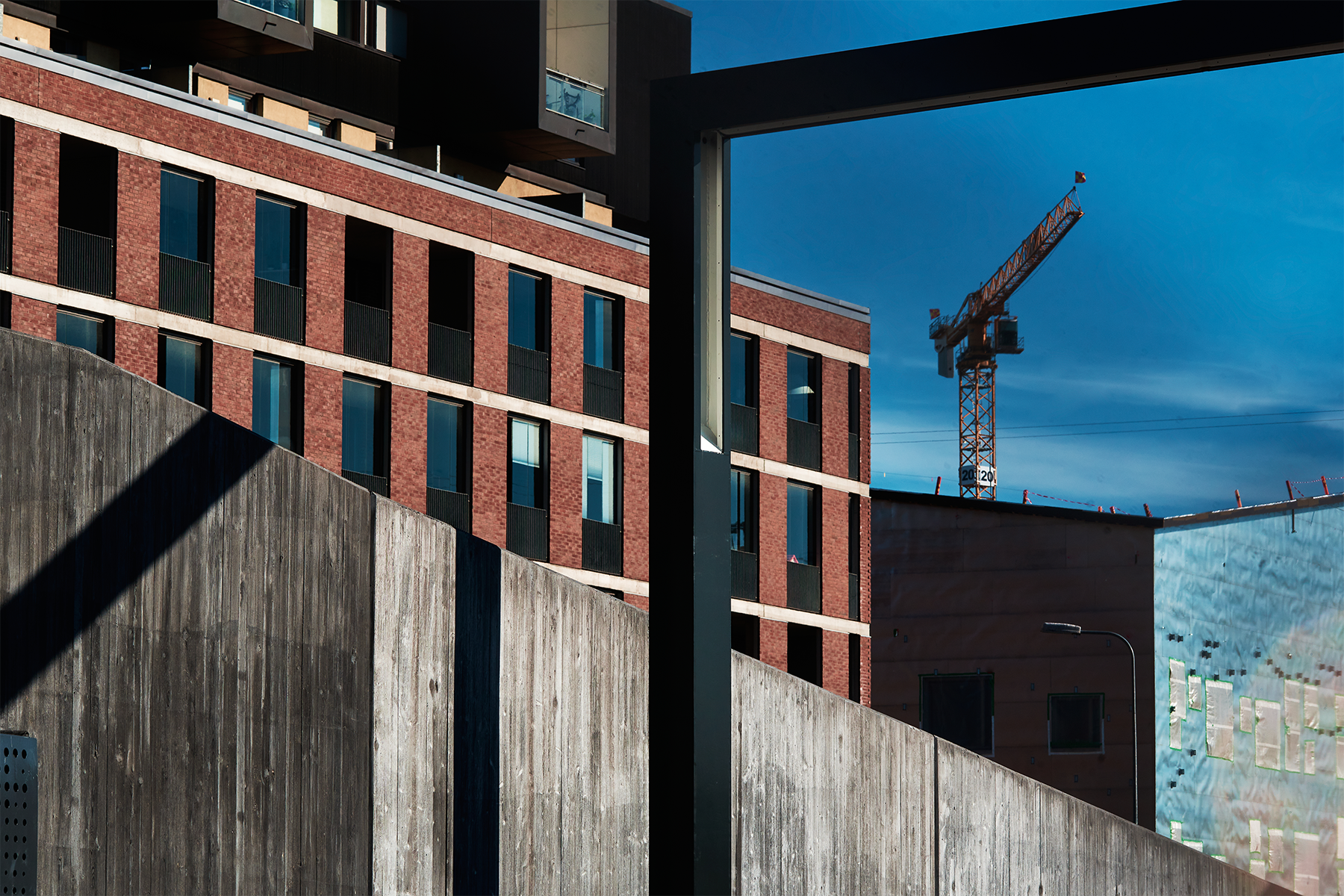  Illustration - a red wall and a blue sky featuring a silhouette of a crane.