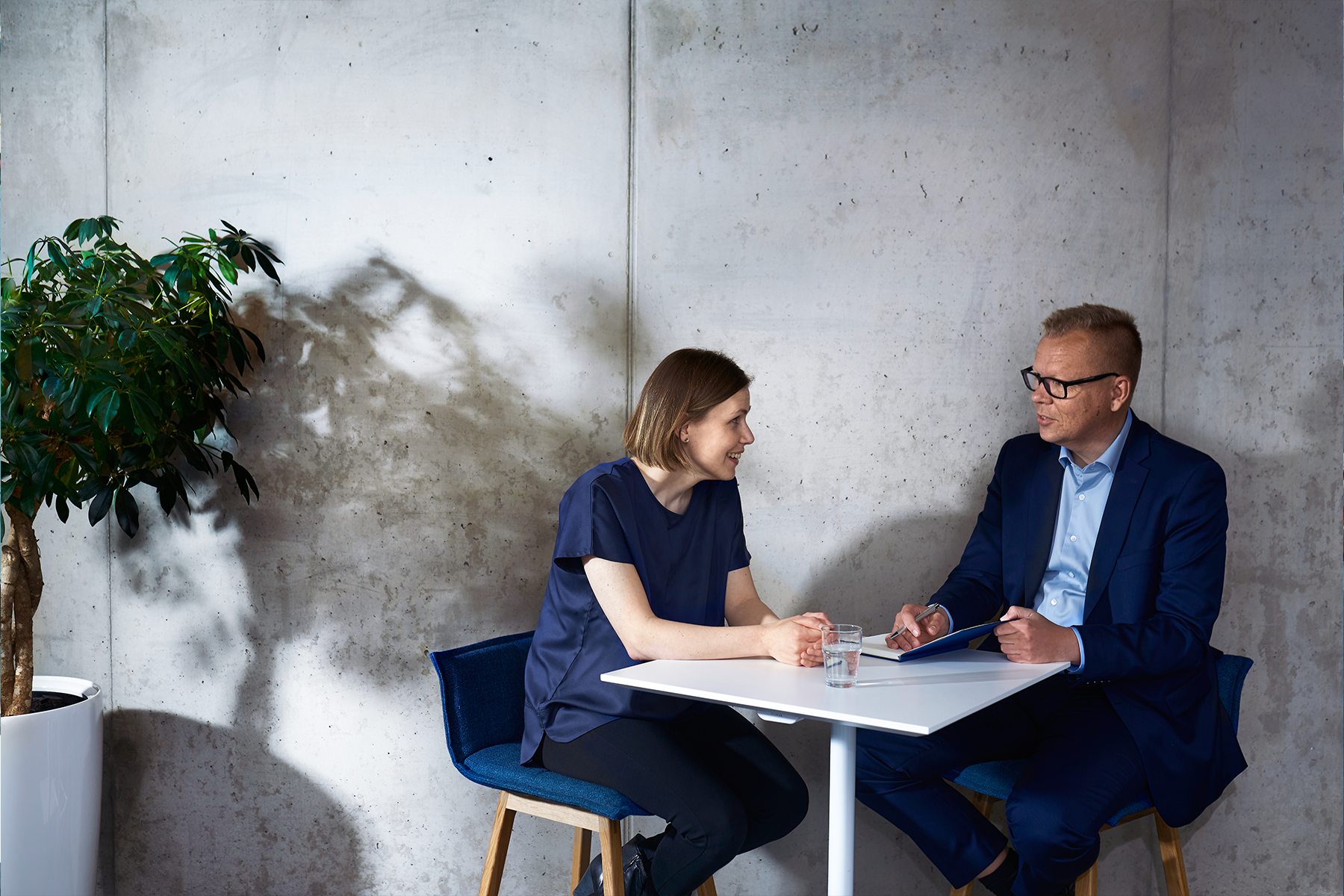 Illustration, two people sitting by a table.