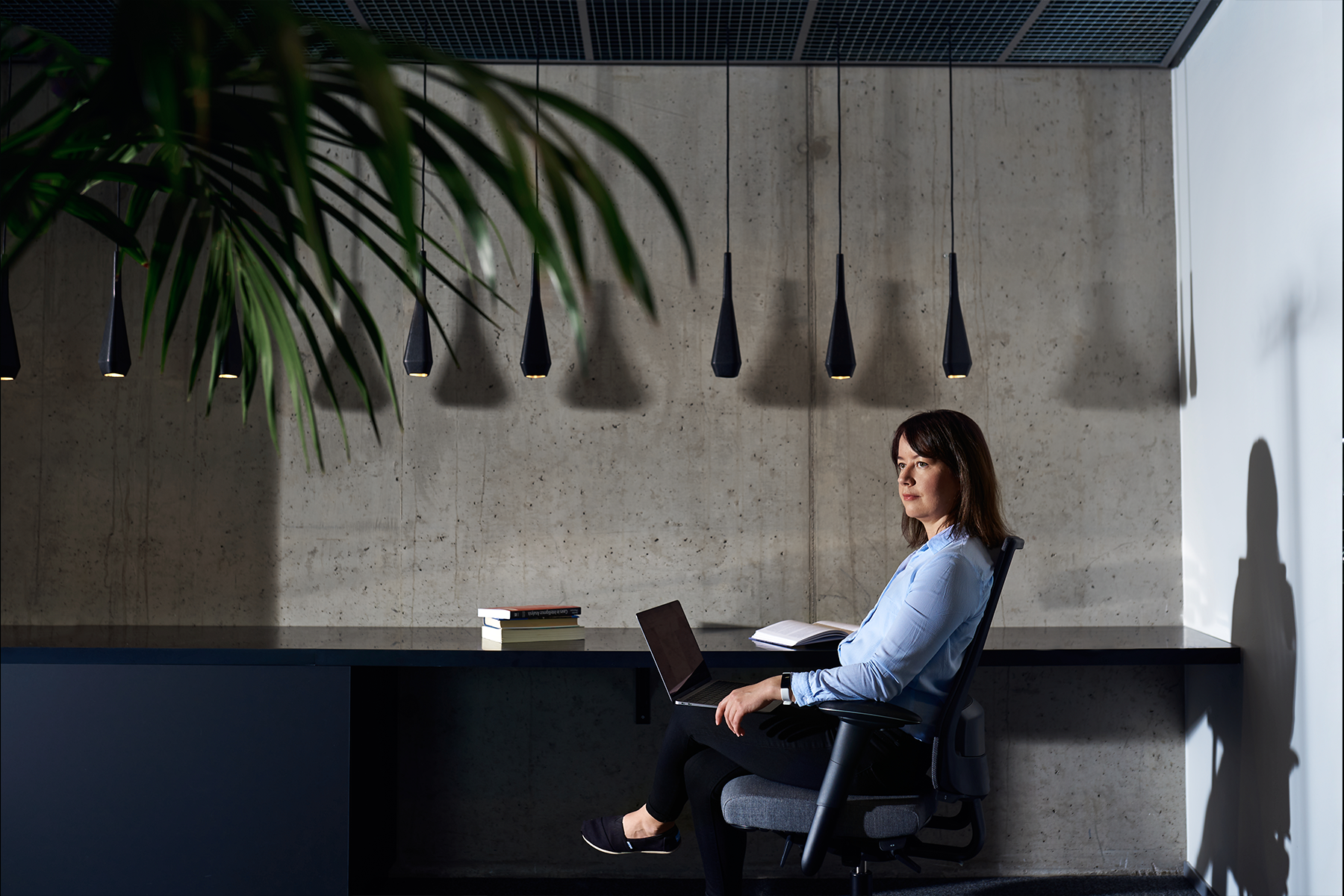  Illustration - a young woman sitting by a desk.